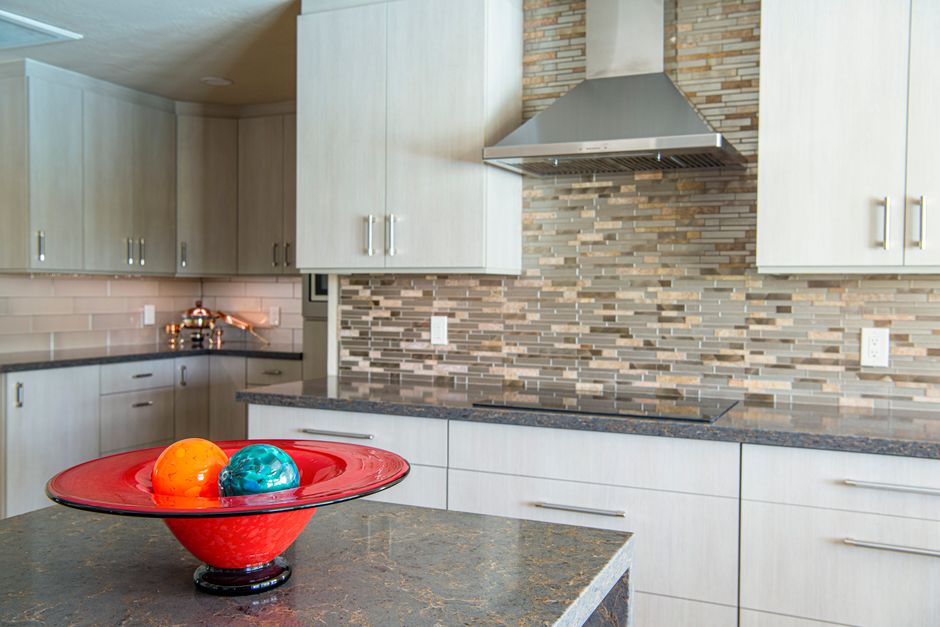 Kitchen with a polished stone countertop and a small bowl on it.